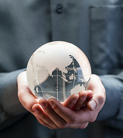 Image of man holding a clear glass globe