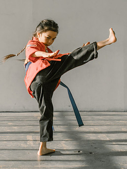 Image of a girl performing a Karate kick
