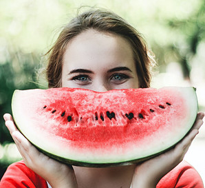 Image of a woman holding a slice of water melon