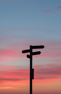 Image of signposts at sunset