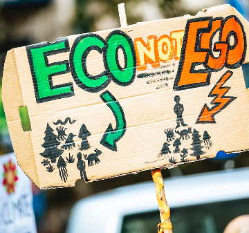 Activists sign reading, Eco not Ego. 