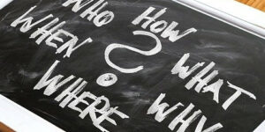 The words: who,what, where, when,why written on a chalk board.