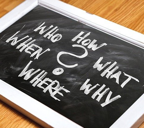 Chalkboard with the words: how, who, what, when, where, why and a big question mark in the middle.