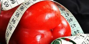 I don't want to be fat anymore. Measure tape wrapped around a red pepper.
