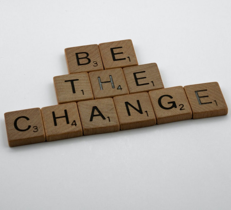 Scrabble tiles forming the words "Be The Change". 