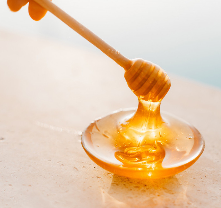 honey dripping from spoon image