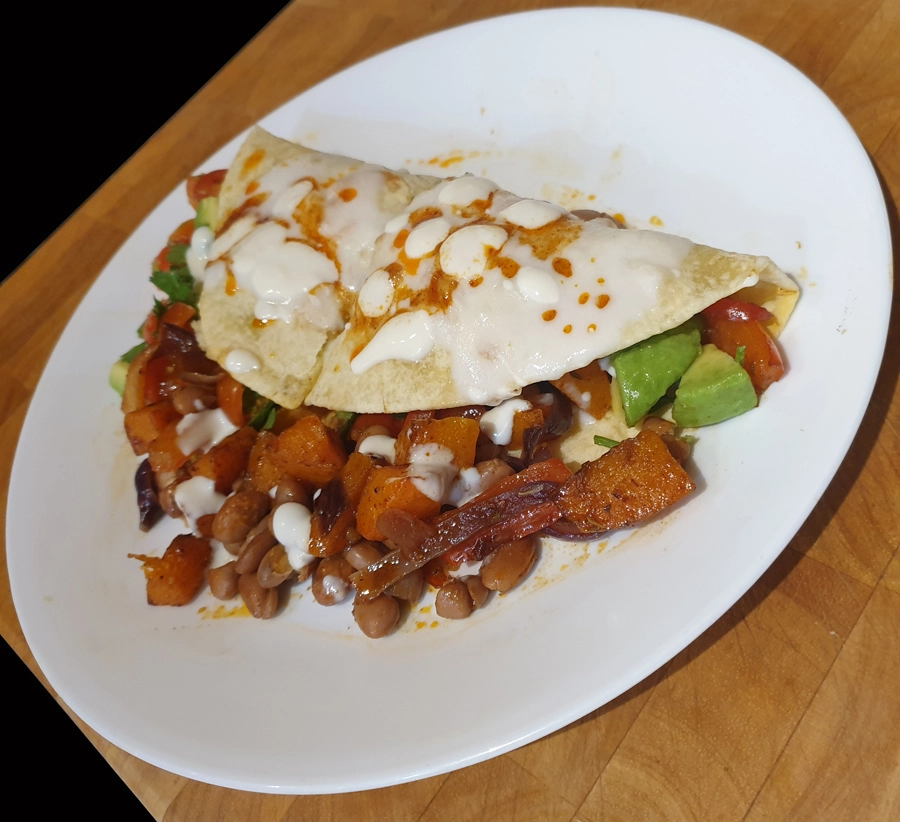 Butternut, Pepper & Pinto Bean Quesadillas With Avocado Salsa plated up. 