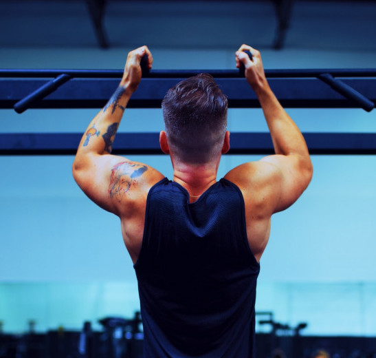 How much soy is too much for a man? (muscled man doing pull ups in the gym)