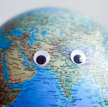 A model globe with googly eyes stuck on it. 