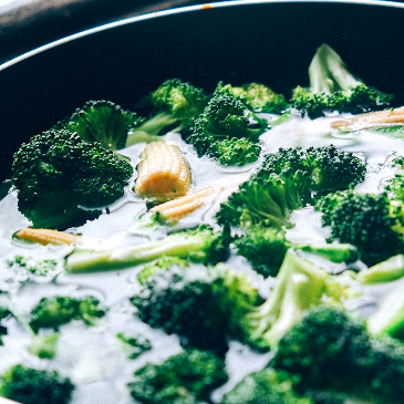 A bowl of tasty looking broccoli green curry in a coconut sauce. 