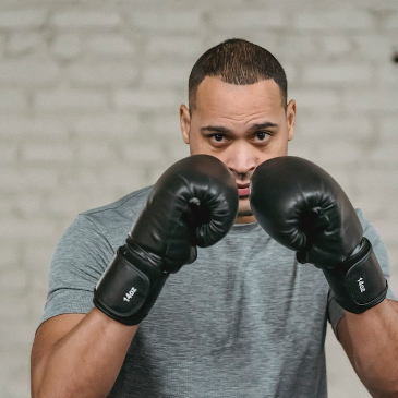 Boxer holding up his gloves in a defensive stance. 