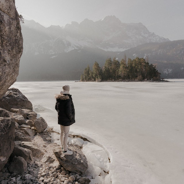 Someone looking over a milky coloured frozen lake. 