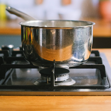 Stainless steel pan boiling on a gas hob. 