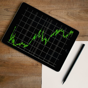 Tablet with green graph lines showing upward growth. 