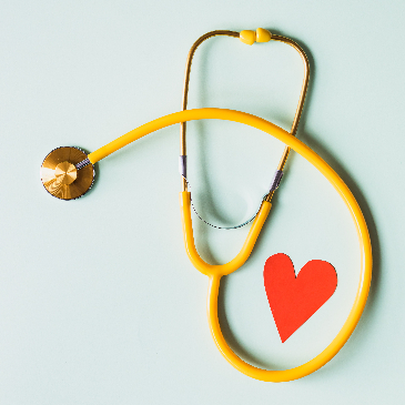Doctor's stethoscope against a light background with a red heart shape standing out. 