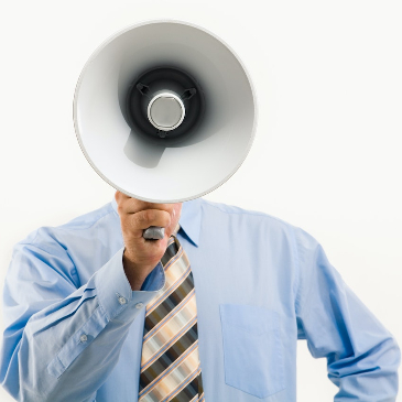 Man in a blue shirt holding a megaphone in front of his face so it looks like his head is the megaphone.
