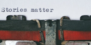 Close up of a typewriter with the text "Stories Matter" on the paper.