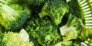 Close up of broccoli florets in a colander.