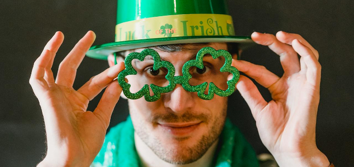 Man with shamrock shaped spectacles on celebrating St Patrick's Day ...