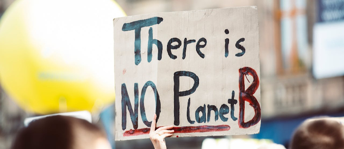 Protester holding a sign that reads "There is NO planet B" 