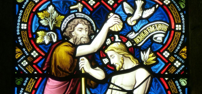 Stained glass window depicting the baptism of Jesus Christ 