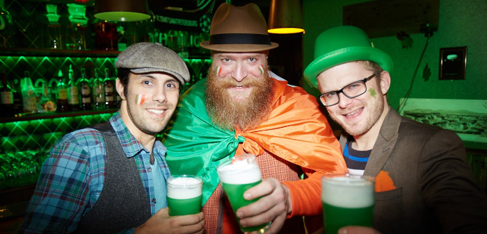 3 men enjoying a drink of something bright green on St Patrick's Day. 